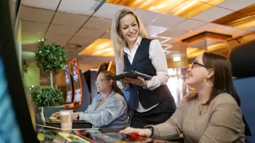 merkur-group-careers-branch-gaming-operations-employee-advises-guests-slot-machines