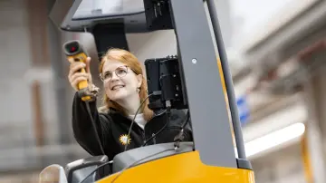 merkur-group-careers-logistics-employee-forklift-scanning-warehouse