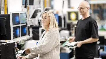 merkur-group-working-environment-production-employee-workstation-colleague-preparing-components